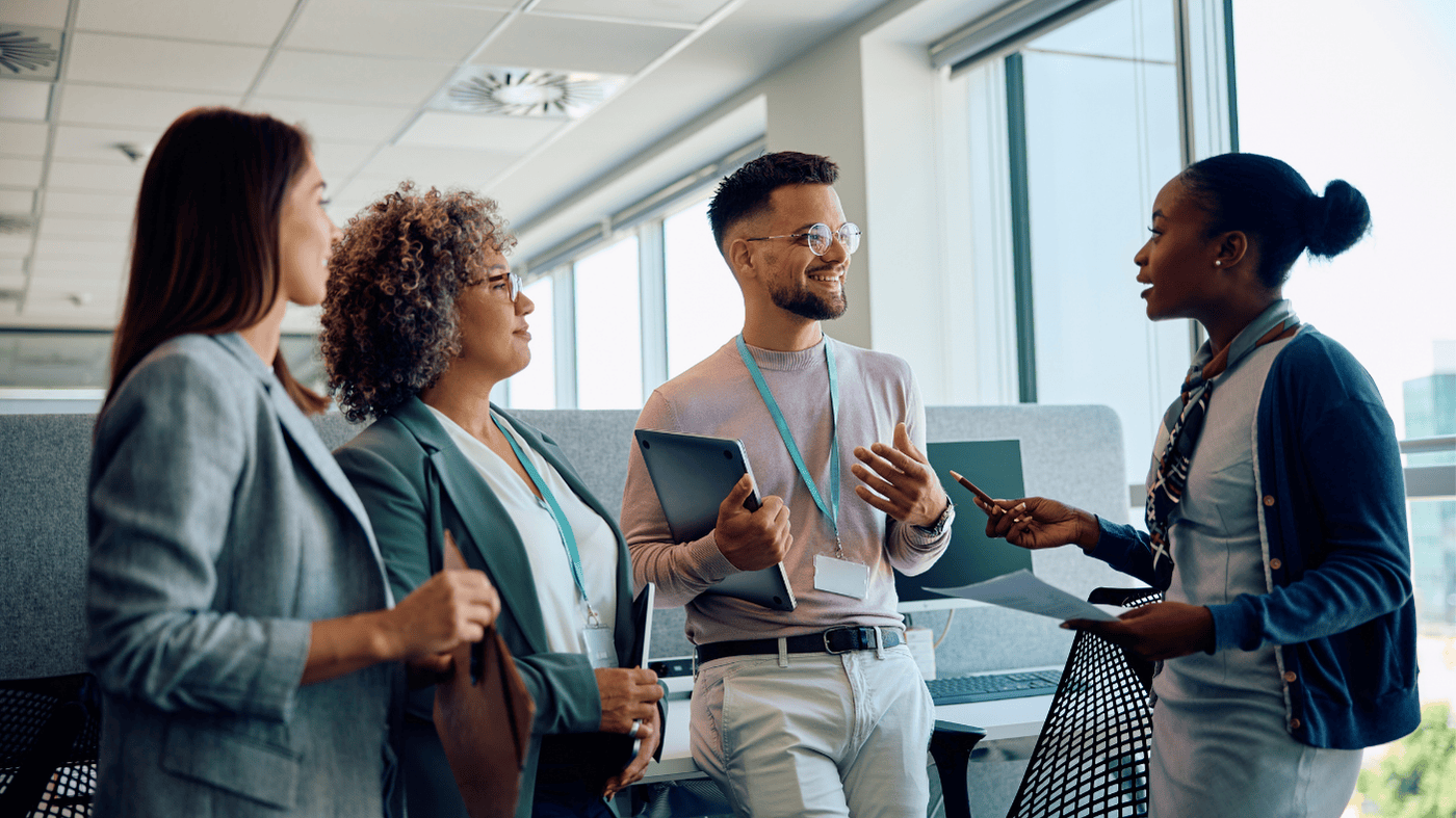 Professionals discussing Change Control vs Change Management in a modern office setting